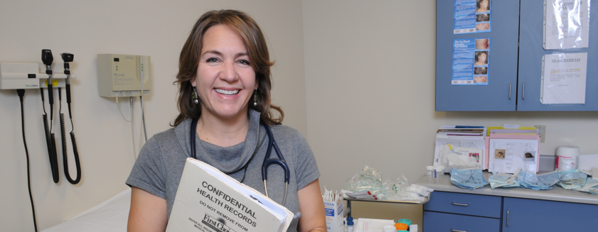 Smiling doctor in exam room