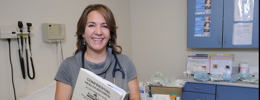 Smiling doctor in exam room